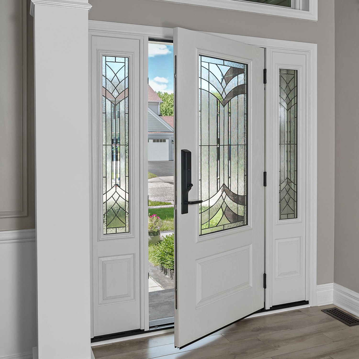 An Ensemble entry door with dual sidelights. The sidelights and door are half-light and feature art glass. The finish is white with black smartlock hardware.