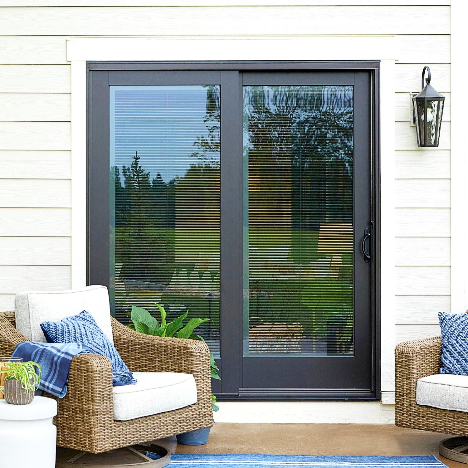 A set of sliding doors on a deck. The doors are sliding so they do not get in the way of the deck chairs.
