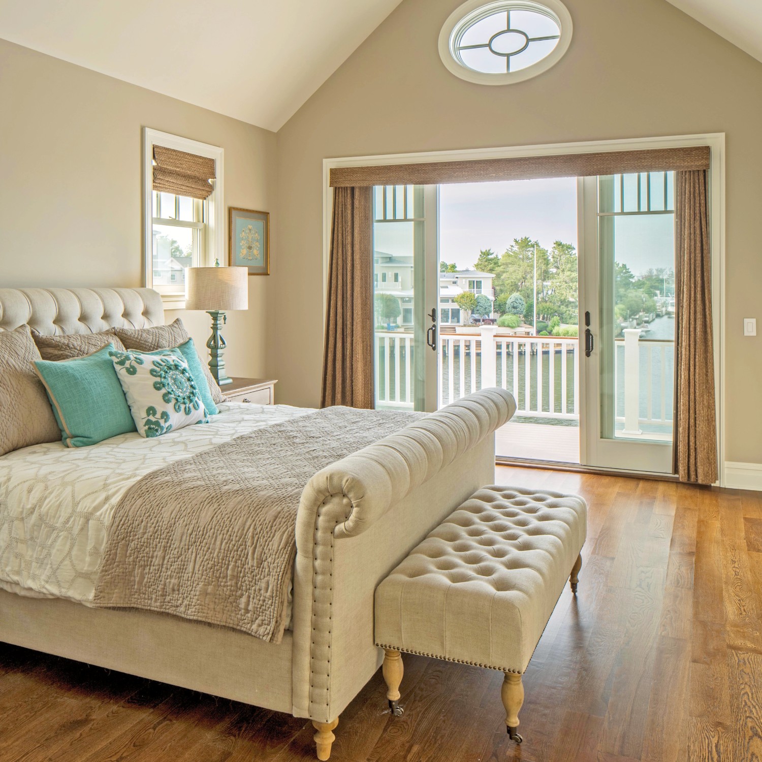 A bedroom with a white sliding door. The room looks out to a harbor.