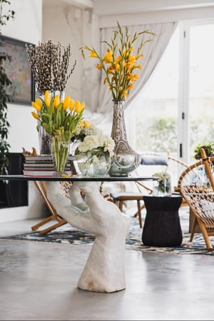 Breegan Jane's family room with a table shaped like a hand holding a platter