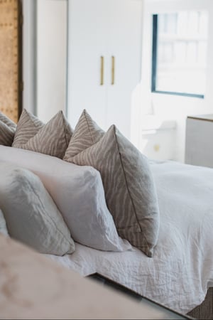 Breegan Jane's guest room showing the bed and a lot of pillows
