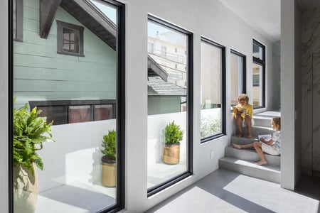 Breegan Jane's front hallway. Her kids are hanging out on the stairs in the sun